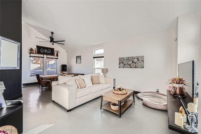 living room with ceiling fan, lofted ceiling, concrete flooring, and a wealth of natural light