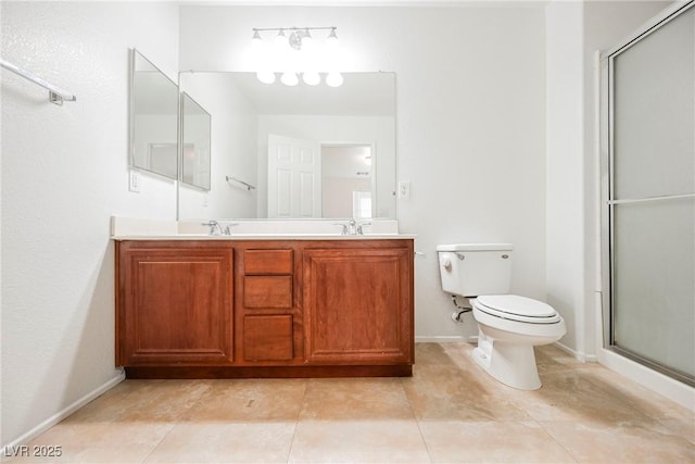 bathroom with vanity, tile patterned flooring, a shower with door, and toilet