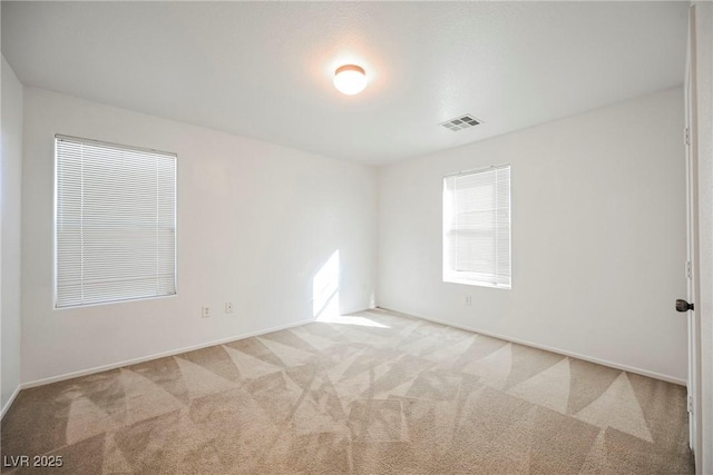 spare room with light colored carpet