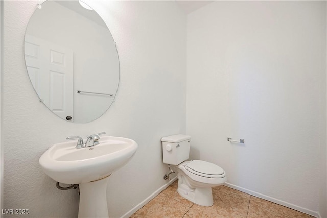 bathroom with tile patterned flooring and toilet