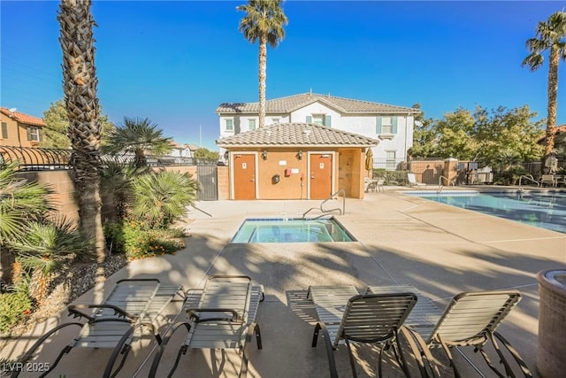 view of pool with a hot tub and a patio area