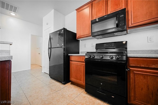 kitchen with light tile patterned floors and black appliances