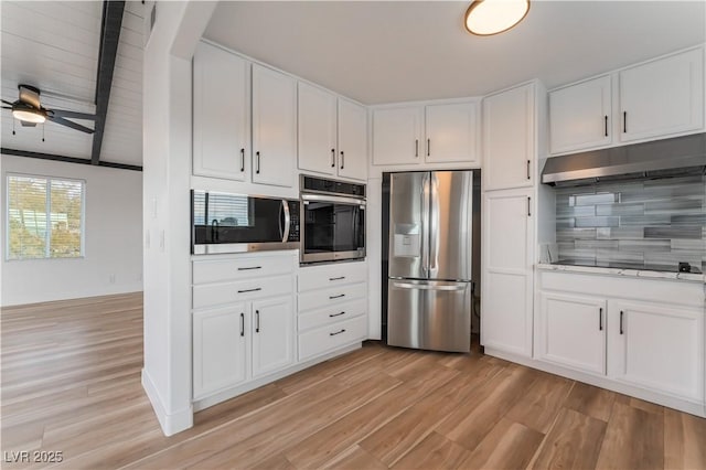 kitchen with stainless steel appliances, white cabinets, light wood-type flooring, and decorative backsplash