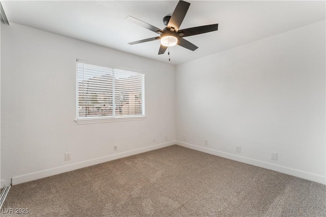 spare room featuring ceiling fan and carpet