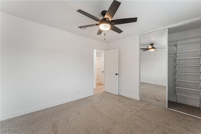 unfurnished bedroom with carpet, ceiling fan, and a closet