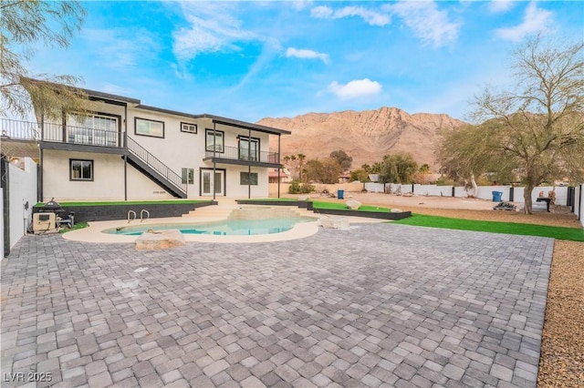 view of pool featuring a mountain view and a patio