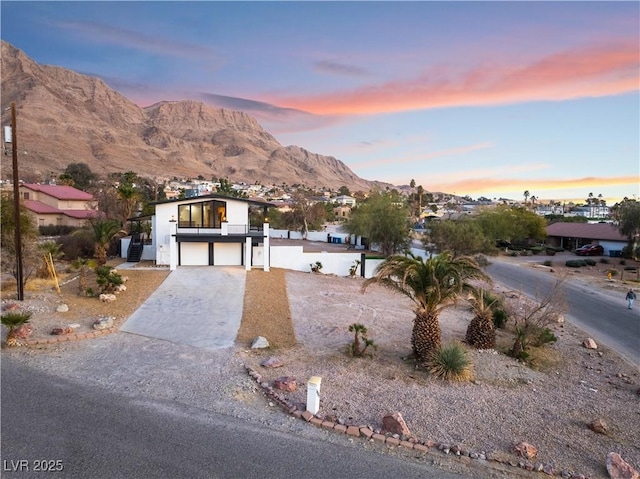 view of front facade featuring a mountain view and a garage