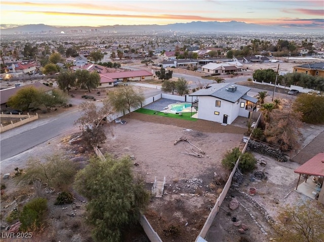 aerial view at dusk featuring a mountain view