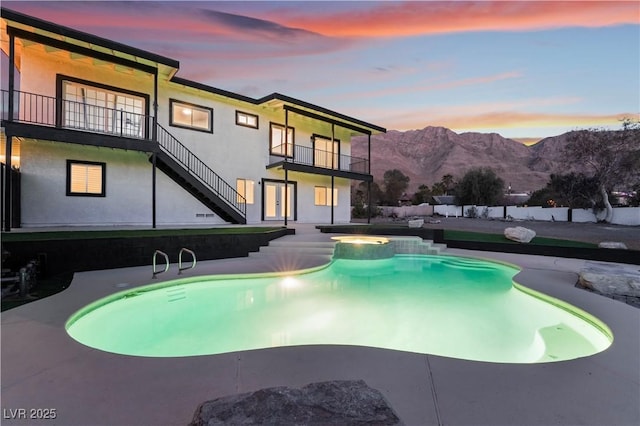 pool at dusk with a mountain view