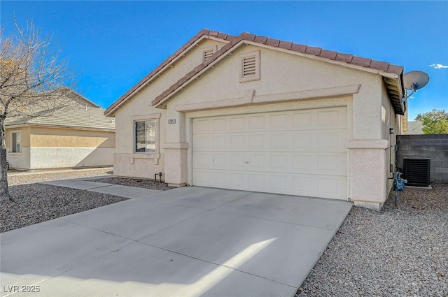 view of front of home with a garage and cooling unit