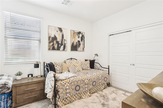 carpeted bedroom with a closet