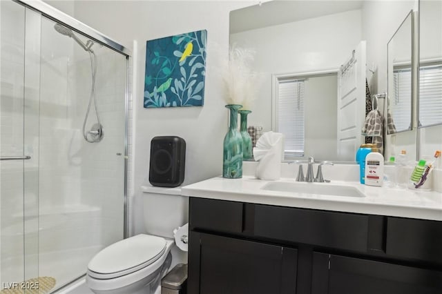 bathroom with vanity, an enclosed shower, and toilet