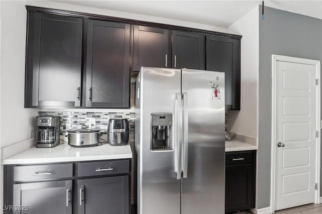 kitchen with tasteful backsplash and stainless steel fridge