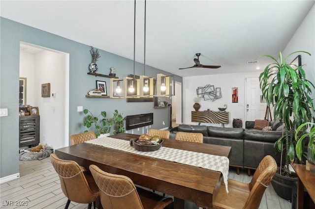 dining area featuring ceiling fan and light wood-type flooring