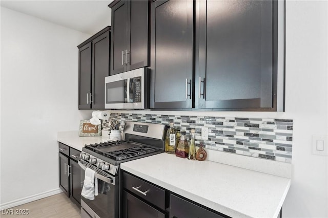 kitchen featuring backsplash, stainless steel appliances, and light wood-type flooring