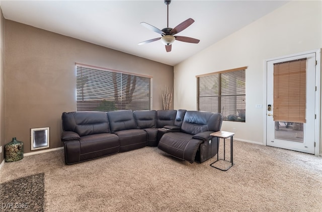 carpeted living area featuring lofted ceiling, ceiling fan, and baseboards