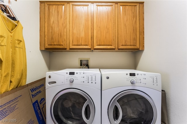 laundry area featuring washing machine and dryer and cabinet space