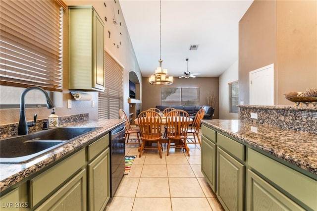 kitchen featuring green cabinetry, a sink, visible vents, and dishwashing machine