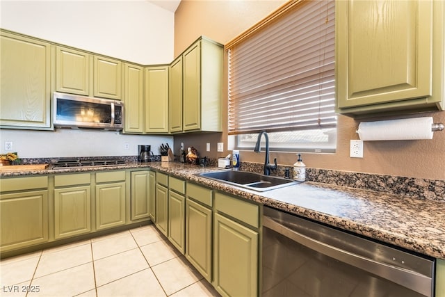 kitchen with a sink, appliances with stainless steel finishes, and green cabinetry