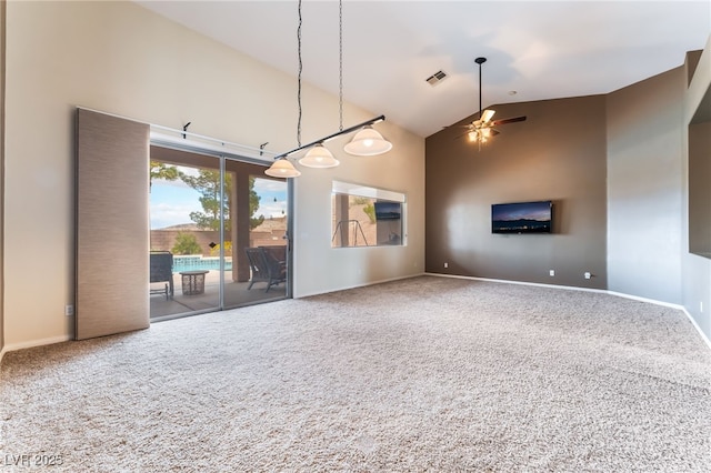 unfurnished living room featuring ceiling fan, high vaulted ceiling, visible vents, baseboards, and carpet