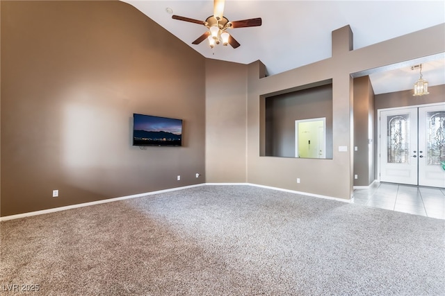 unfurnished room with ceiling fan, high vaulted ceiling, carpet flooring, baseboards, and french doors