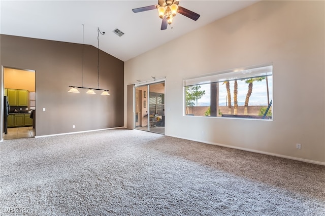 unfurnished living room featuring high vaulted ceiling, light colored carpet, visible vents, and a ceiling fan