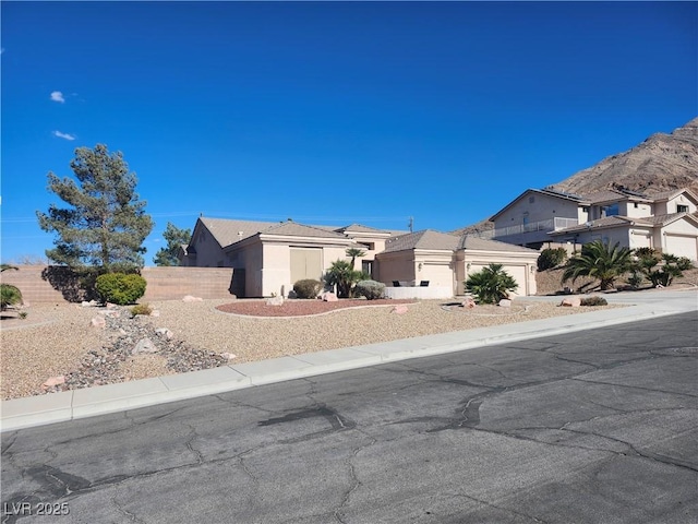 view of front of house featuring fence and stucco siding