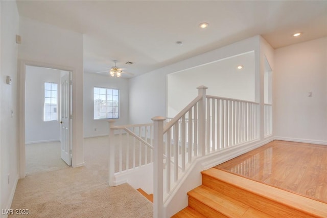 stairs with carpet and ceiling fan