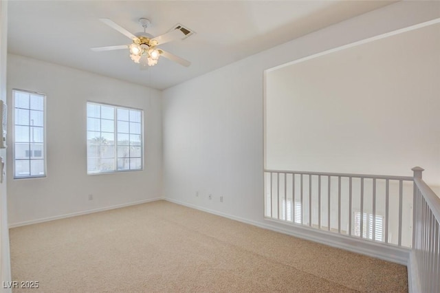 unfurnished room with ceiling fan and carpet flooring