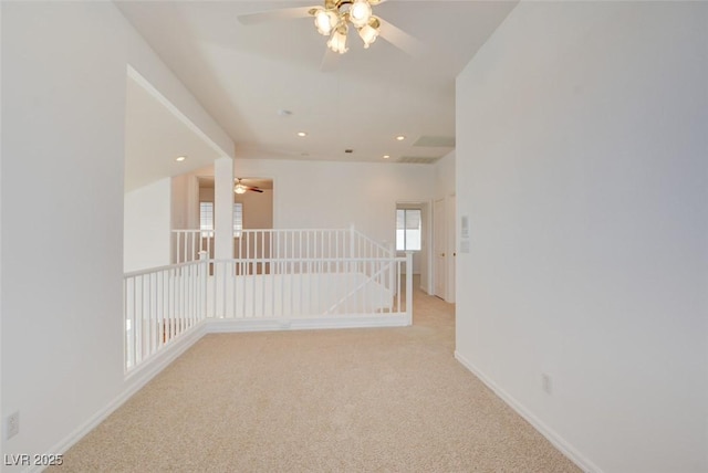 spare room with light colored carpet and ceiling fan