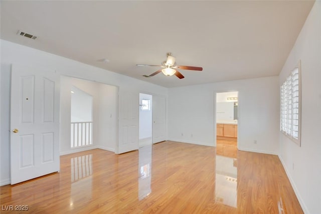 spare room featuring ceiling fan and light hardwood / wood-style floors