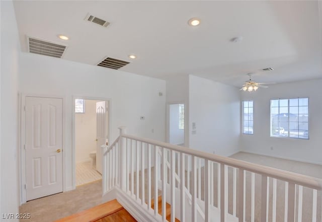 hallway featuring light colored carpet