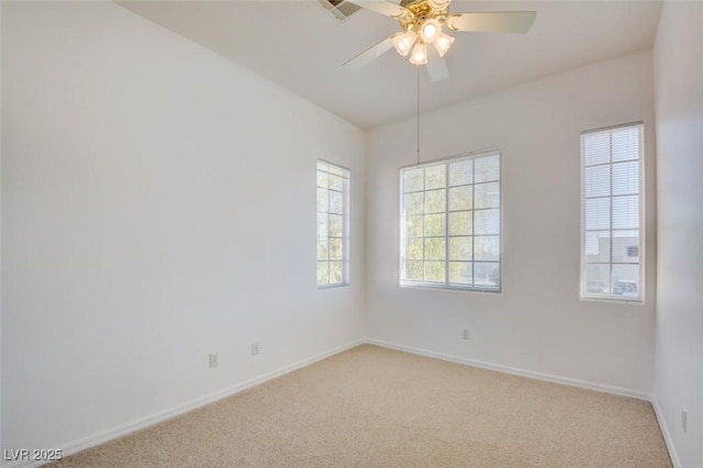 spare room with light colored carpet and ceiling fan