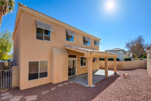 back of property featuring a patio