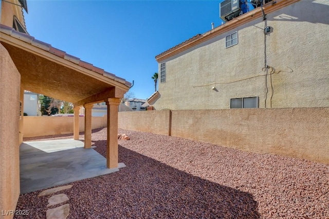 view of yard featuring cooling unit and a patio area