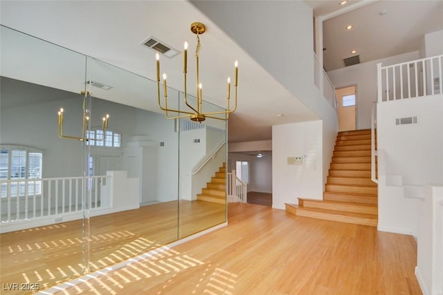 interior space featuring hardwood / wood-style floors, a chandelier, and a high ceiling