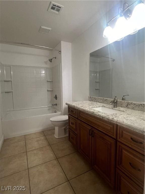 full bathroom featuring tiled shower / bath, vanity, tile patterned floors, and toilet