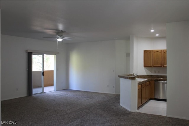 kitchen with ceiling fan, light colored carpet, dishwasher, and kitchen peninsula