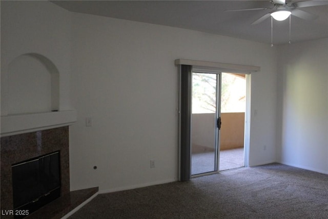 unfurnished living room with a fireplace, ceiling fan, and carpet