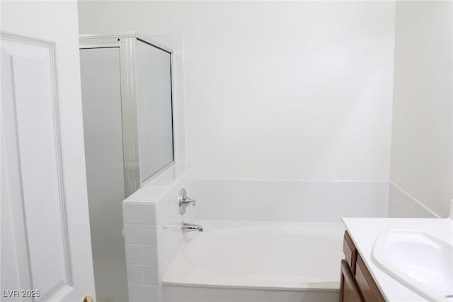 bathroom with vanity and a tub