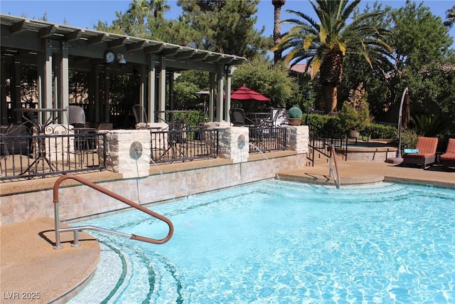 view of swimming pool with a pergola and a patio