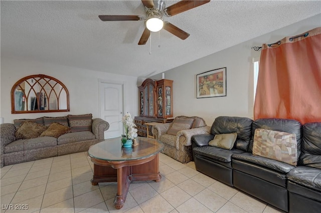 tiled living room featuring ceiling fan and a textured ceiling