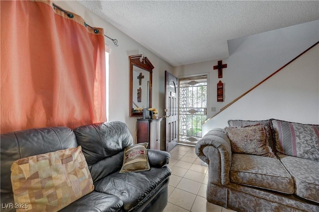 living room with a textured ceiling and light tile patterned floors