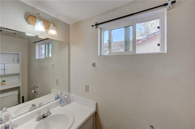 bathroom featuring vanity and toilet