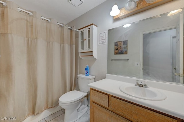 bathroom with tile patterned flooring, vanity, and toilet