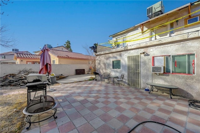 rear view of property with cooling unit, a balcony, a patio, and central air condition unit