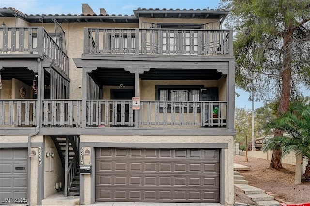 view of property with a garage and a balcony