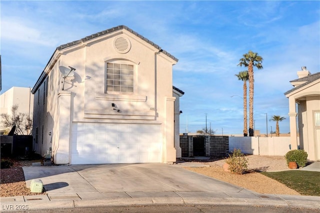 exterior space with a garage, fence, concrete driveway, and stucco siding