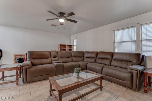 living area with light tile patterned floors, visible vents, and a ceiling fan