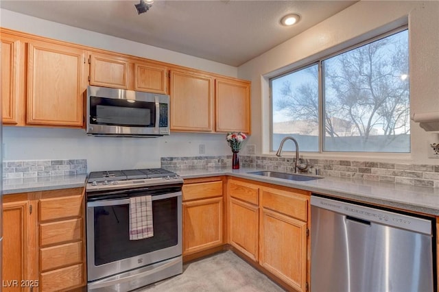 kitchen featuring backsplash, stainless steel appliances, sink, and light brown cabinets